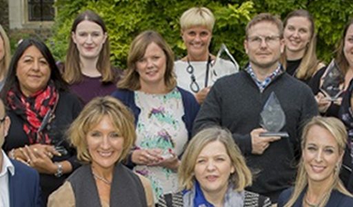 Group of poeple smiling with awards