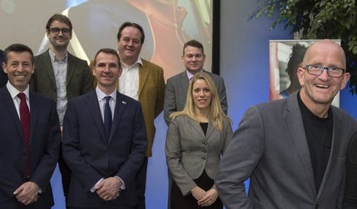 Group of people smiling with Eddie The Eagle