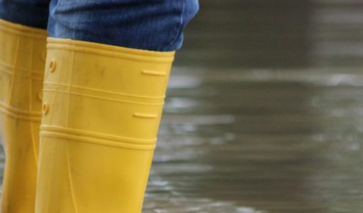 person wearing wellie boots in a flood