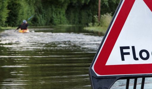 Flood sign on a flooded road
