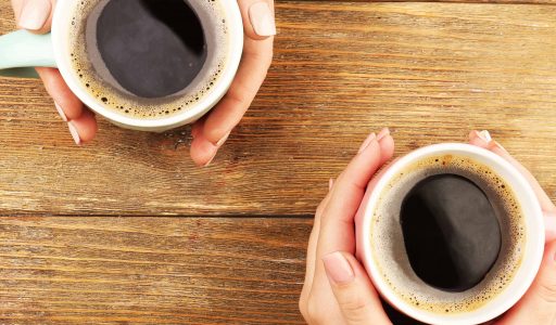 Two people holding coffee cups